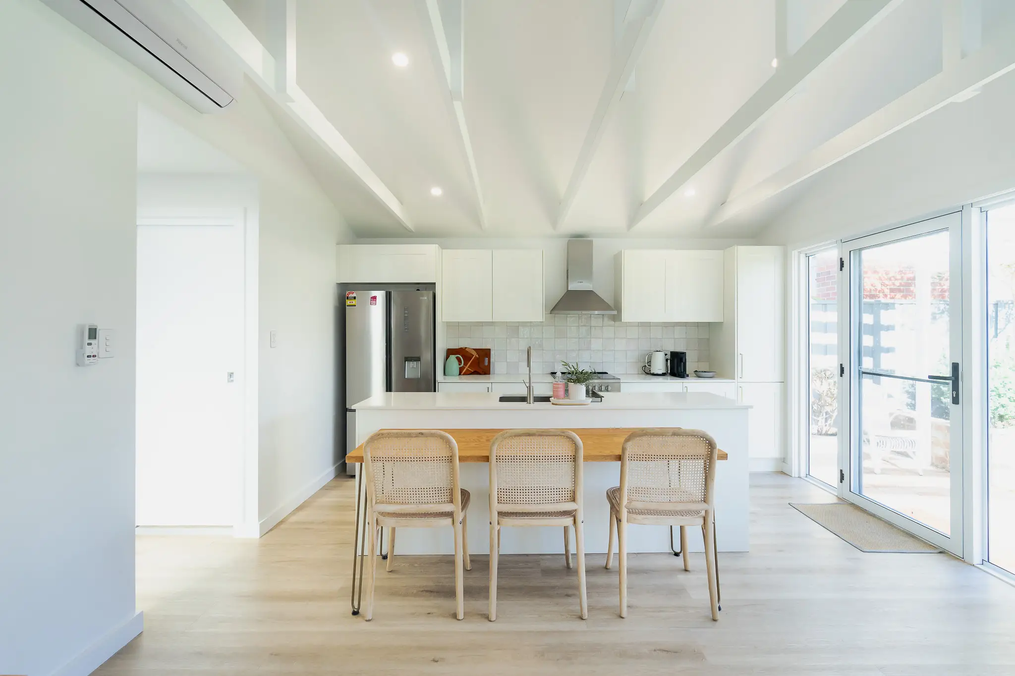 kitchen with white cabinets and white tiling